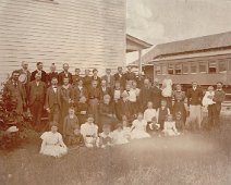 Grandmother at the train station "After a reunion at the train station in Almond. Ethel Karr is seated on the ground in a white dress at the far left , her father Charles Karr standing at far...