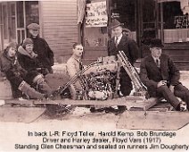 Harley Dealer In back L-R: Floyd Teller, Harold Kemp, Bob Brundage, Driver and Harley dealer, Floyd Vars (1917) Standing Glen Cheesman and seated on runners Jim Dougherty