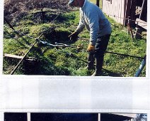 Oil17 Terry shown hooking on or off a rod line. This simple chore was one of the many dangerous tasks on an oil lease...many fingers lost. From Dick Fitch Collection