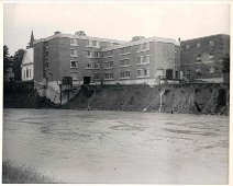 HospitalReadyToCollapse-betweenStorms Hospital foundation is shown undermined by the river's rushing waters...collapse is a probability. Photo by Dick Neal