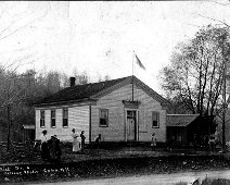 6-Wirt District 6 The "pink schoolhouse", Wirt district #6, 1914, Gertrude Wells is the teacher on the left. Gertrude was the eldest of the six Ernest Wells children (Gertrude,...